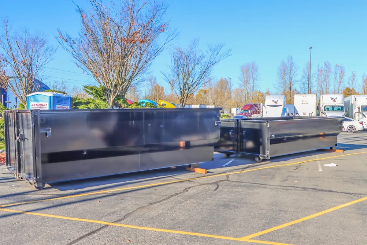 Professional dumpster rental service with roll-off container on residential driveway in Hobart